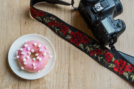 Pink donuts with a reflex cameraの写真素材