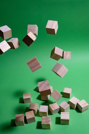 Wood cubes flying on the green backgroundの写真素材