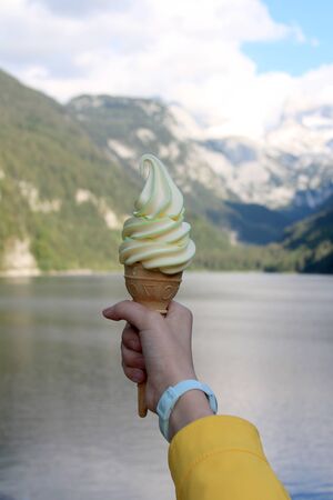 multi-colored ice cream in a horn in a hand