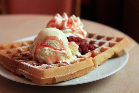 a scoop of ice cream on the Vienna waffle syrupの写真素材