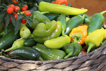 bell peppers in a wicker basketの写真素材