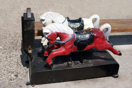 Retro miniature white and red horses rideの写真素材