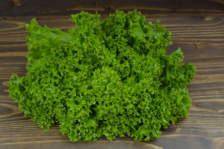 fresh cabbage leaves on a wooden boardの写真素材