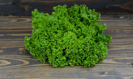 fresh cabbage leaves on a wooden boardの写真素材