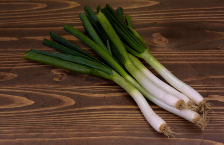 young green onion on a wooden boardの写真素材