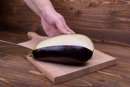 cutting the eggplant on a wooden boardの写真素材