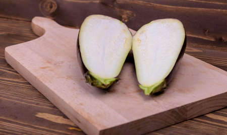 cutting the eggplant on a wooden boardの写真素材