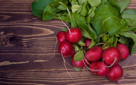 bunch of radishes on a wooden boardの写真素材