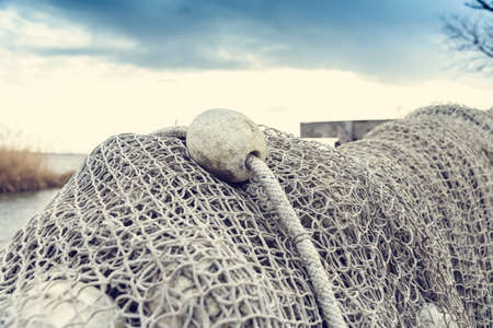 Old fishing nets drying beside the lakeの写真素材