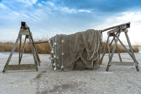 Old fishing nets drying beside the lakeの写真素材