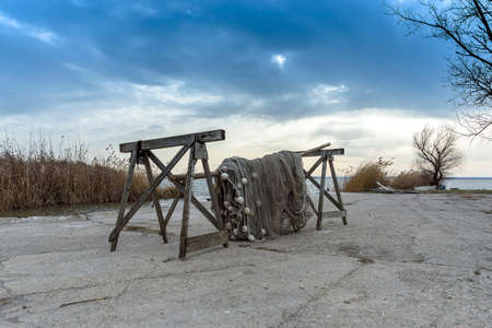 Old fishing nets drying beside the lakeの写真素材