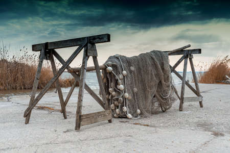 Old fishing nets drying beside the lakeの写真素材