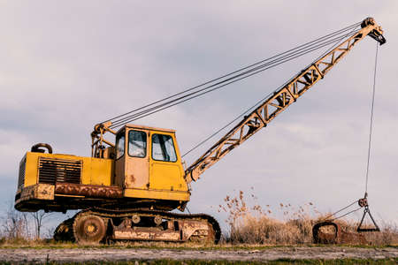 Old rusty excavator for extracting fishの写真素材
