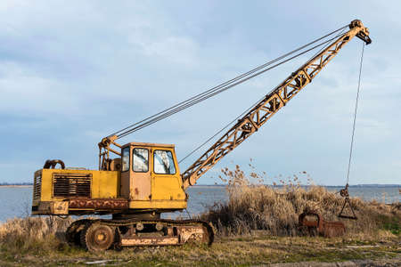 Old rusty excavator for extracting fishの写真素材