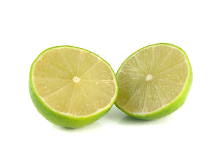 Isolated two halfs of green limes on a white background. Fresh diet fruit. Healthy fruit with...