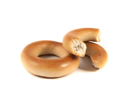 Bagels isolated on white background (two). Broken bagel.の写真素材