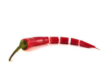 Sliced red chili hot pepper on white background. Isolated healthy vegetable.の写真素材