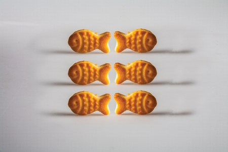 Fish-shaped biscuit background unit isolateの写真素材