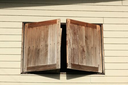 Opened Wooden Windows on the wallの写真素材