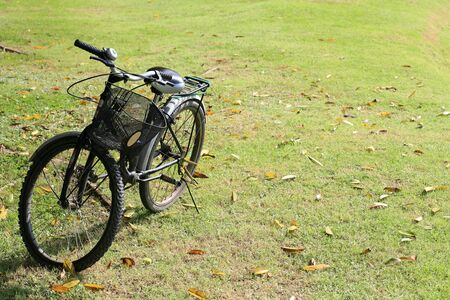 Bicycle parked on the grass field の写真素材