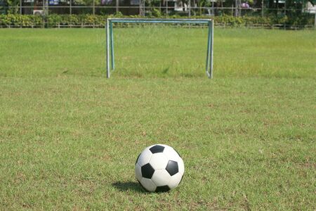Background: Soccer ball and small goal on the field の写真素材