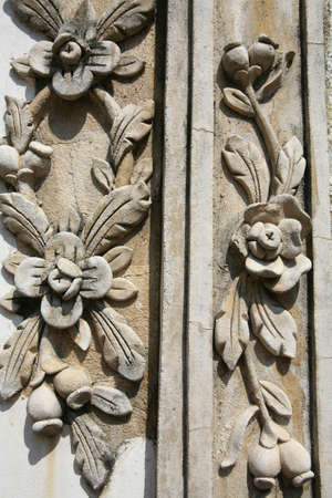 Ornament: detail of ancient flower carving on temple wallの写真素材