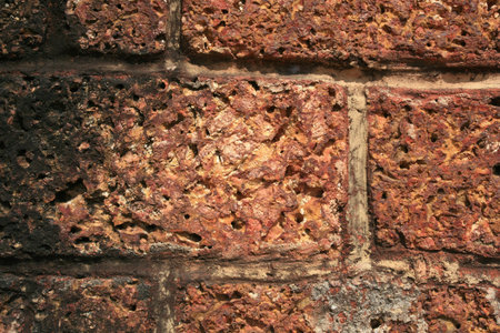 Pattern background: aged rough brick wall 