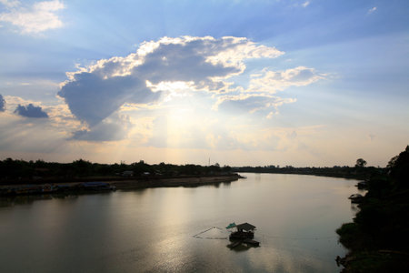 Silhouette background: light through the cloud with river lifestyle scene