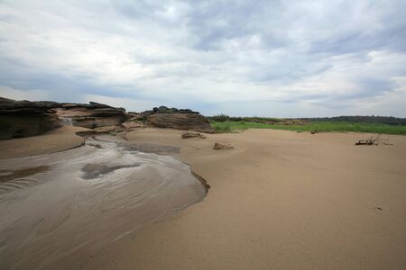 Travel background   natural landscape of sand, islet, plant after raining at Sampanbok in Thailandの写真素材