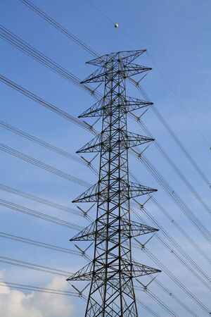 isolated electrical tower against blue sky and cloudの写真素材