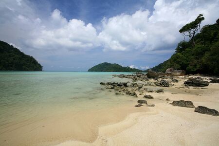 Travel background  beautiful beach and natural stones against blue sky at Surin islands national park, Thailandの写真素材
