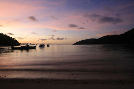 Travel background  silhouette scene of tropical beach before sunrise at Surin islands national park, Thailandの写真素材