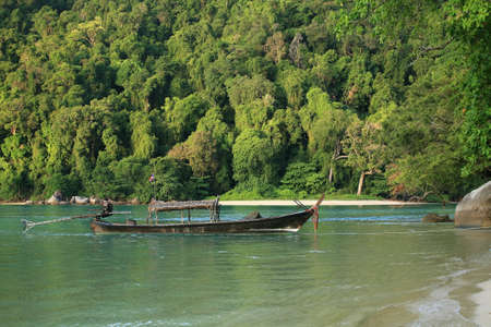 Travel background  long-tailed boat parking near tropical beach in the morning の写真素材
