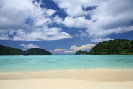  tropical landscape scenic while long-tailed boat riding on transparent sea with blue sky at Surin islands national park, Thailand の写真素材