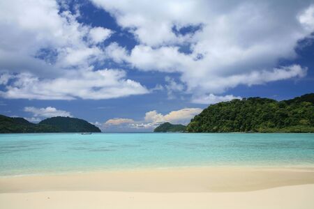 Travel background  tropical Andaman landscape while long-tailed boat riding on transparent sea with blue sky at Surin islands national park, Thailand の写真素材