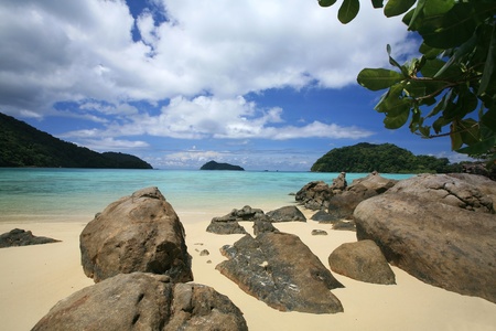 Travel background  natural stones and beautiful tropical coastline against blue sky and cloud at Surin islands national park, Thailandの写真素材
