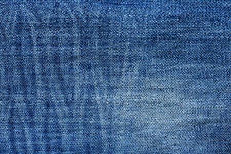 Textured pattern  closeup of worn blue denim jeansの写真素材