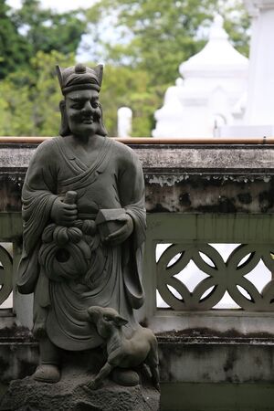 Chinese god with goat statue near temple boundaryの写真素材