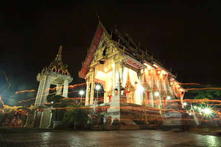 Candle light trail around the pagoda for Buddhism Ceremony on Asalha Puja day at wat Chomphuwek in...