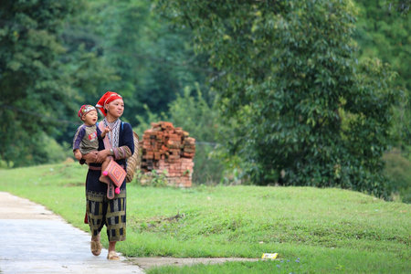 SAPA-JUL 23  Unidentified hill tribe mother with her son walks down from the Red Dao Minority village on July 23, 2012 in Sapa, Vietnam  Red Dao Minority are the 9th largest ethnic group in Vietnam のeditorial素材