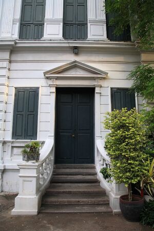 Front Door of antique building with plant decoration in Bangkok,Thailandの写真素材