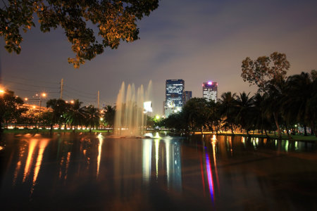 BANGKOK-SEP 28  Chatuchak park with TMB Head office building at dusk on September 28, 2012 in Bangkok, Thailand  TMB, Thai Military Bank established in 1957, provides financial services to military  のeditorial素材