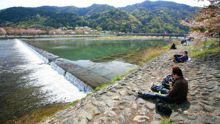 ARASHIYAMA-APR 17  Unidentified people have Hanami, enjoy of cherry blossom, party near Togetsukyo bridge on April 17, 2011 in Arashiyama, Kyoto outskirt, Japan  Here is famous on sakura bloom time  のeditorial素材