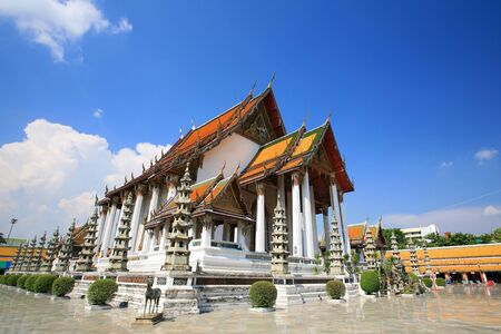 Beautiful temple architecture of wat Suthat Thepphawararam against blue sky in Bangkok, Thailandの写真素材