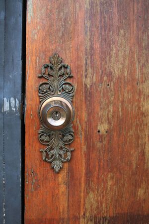 Antique metal knob on old wooden brown doorの写真素材