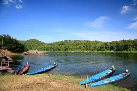 Longtailed wooden boats parking on the river at Huai Krathing in Loei, Thailand の写真素材