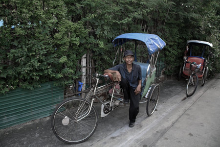 BANGKOK-NOV 10  Unidentified rider sits on the old rickshaw on November 10, 2012 in Bangkok,...