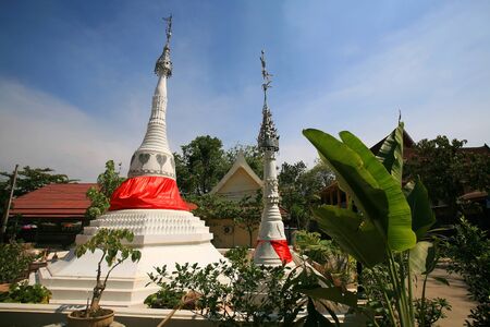 Ancient white pagodas against blue sky at wat Bang Chak in Nonthaburi province, Thailand の写真素材