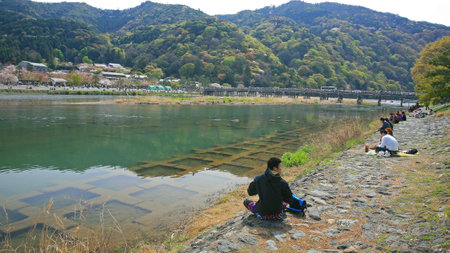 ARASHIYAMA-APR 17  Unidentified people have Hanami, enjoy of cherry blossom, party near Togetsukyo bridge on April 17, 2011 in Arashiyama, Kyoto outskirt, Japan  Here is famous on sakura bloom time  のeditorial素材