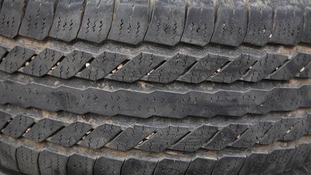 Old dark tire texture attached by pebbleの写真素材